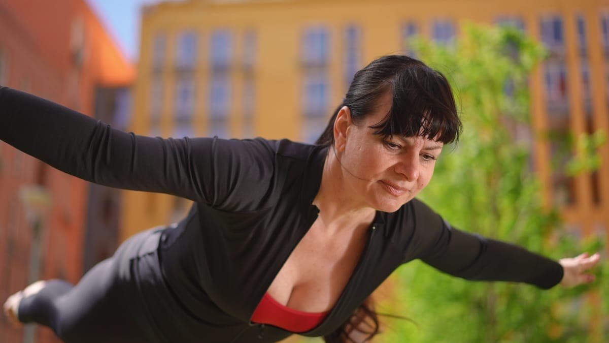 Woman lying awake in bed at night, unable to sleep, looking stressed