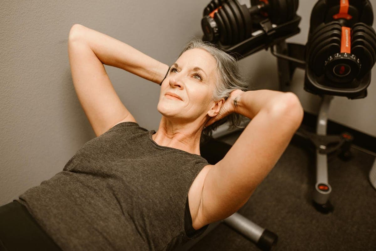 Woman sleeping peacefully during menopause with soft lighting, representing restful sleep and hormonal balance