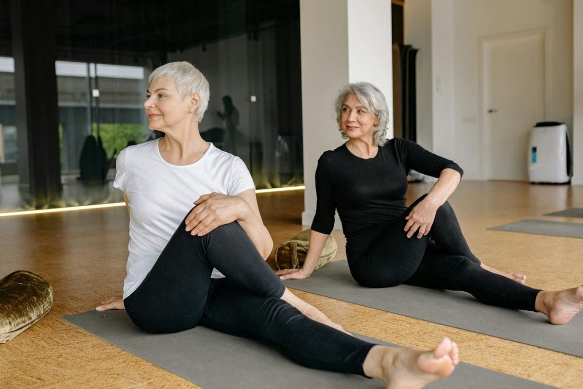 Woman resting her hand on her abdomen while experiencing perimenopause symptoms